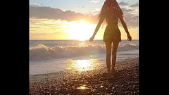 Sunset girl at the sea beach Thumb