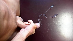 Twink wanking and jerking off a huge cumload on a desk Thumb