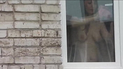 Naked in public. Nude. Outdoor. Outside. Husband Sexy Frina is spying on her from car window when she washes apartment window no panties and bra. Thumb