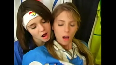 Girls from argentina and italy football uniforms have a nice time at the locker room Thumb